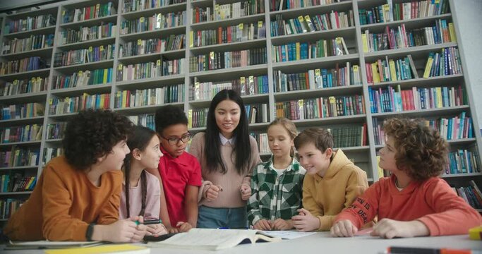 Asian teacher and children rejoice after completing project