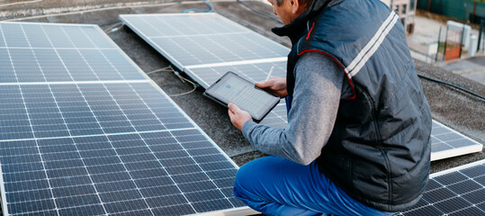 Solar energy engineer using tablet for check power station. Alternative energy system. eco concept