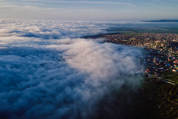 Aerial view with clouds and mountains. Foggy spring weather