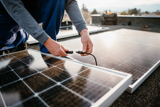 Worker installing solar energy panels. Alternative energy system. eco concept