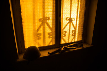 Conceptual photo of war between Russia and Ukraine. Ukraine and Russia flags on windowsill at...