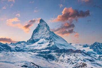Idyllic view of snowcapped matterhorn mountain peak. Famous snow covered landscape against sky...