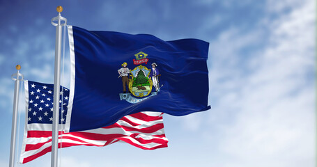 The Maine state flag waving along with the national flag of the United States of America