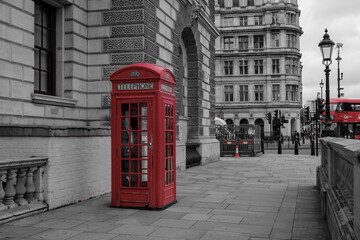 Fototapeta na wymiar Classic British view: Red phone booth in London, UK