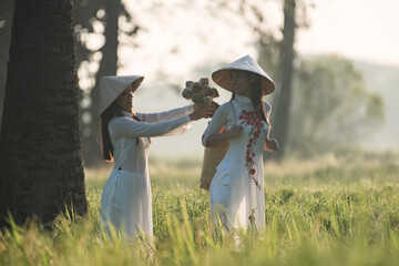 beautiful woman with Vietnam culture traditional dress, Ao dai and in fileds.