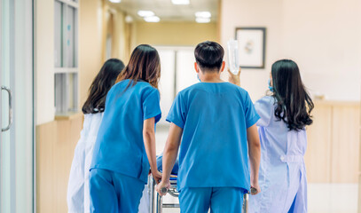 Group of professional medical doctor team and assistant with stethoscope in uniform taking seriously injured coma patient to operation emergency theatre room in hospital.health medical care concept