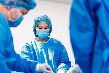 Professional anesthesiologist doctor medical team and assistant preparing patient to gynecological surgery performing operating with surgery equipment in modern hospital operation emergency room