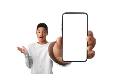 Troubled African-American teenage boy showing mobile phone with blank screen on white background