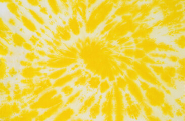 The fabric is painted in yellow and white in tie dye style. Flat lay.