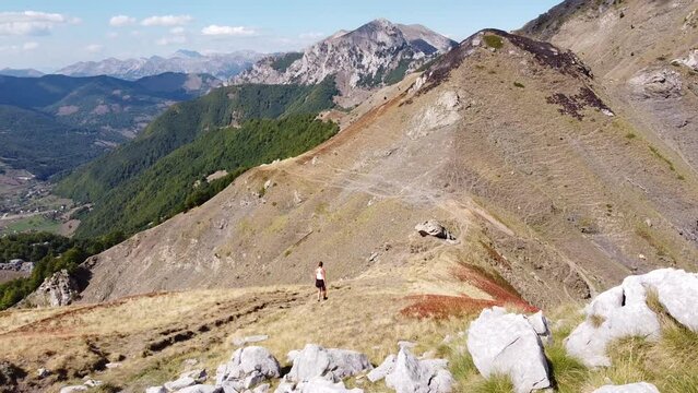 Woman Hikes Downhill a Mountain Trail in Prokletije National Park, Montenegro - Dolly Follow