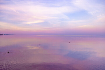 Sky background on sunset, colorful clouds. Nature abstract composition with reflections on sea...