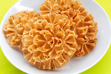 Crispy lotus blossom cookie in white plate
