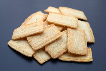 Cheese crispies on dark background.