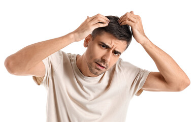 Worried young man with hair loss problem on white background