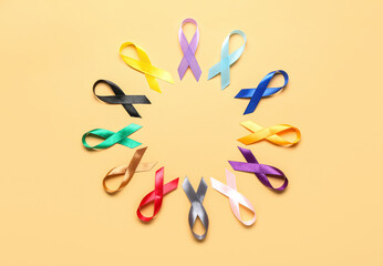 Circle frame made of awareness ribbons on color background. World Cancer Day concept