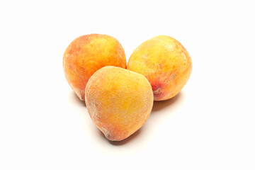 Group of fresh peaches fruit over a white background