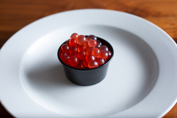 A view of a condiment cup filled with popping boba.