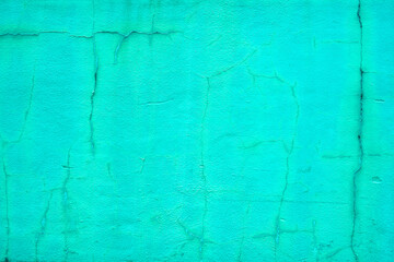 Fototapeta na wymiar Rough vintage cracked bright green stucco background