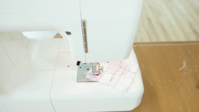 Sewing cotton face mask with a sewing machine for coronavirus outbreak.