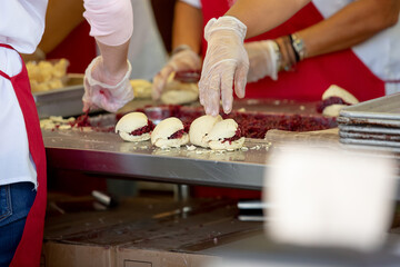 A view of employees making raspberry jam filled scones at a local fair in Puyallup, Washington.