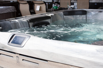 A view of a hot tub on display at a fair vendor tent.