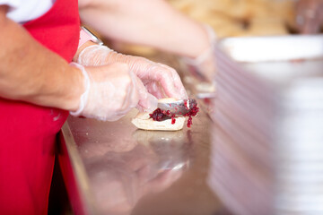 A view of employees making raspberry jam filled scones at a local fair in Puyallup, Washington.
