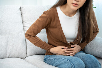 Obraz premium stomach ache. Women have abdominal pain, indigestion, gastritis, gastroesophageal reflux, menstrual cramps, diarrhea, abdominal distension.