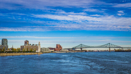 View on the St Lawrence river, Jacques Cartier Bridge, Molson factory and Montreal Old Port clock tower from the Jean Drapeau Park
