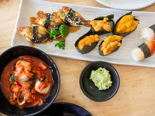 Top view of big meal with assorted and various sushi and kimchi, Japanese food. Korean food.