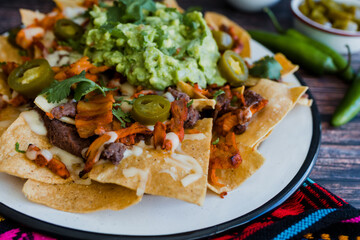 Mexican nachos chips with american cheese and avocado, traditional food in Mexico Latin America