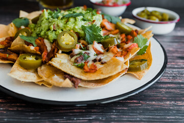 Mexican nachos chips with american cheese and avocado, traditional food in Mexico Latin America