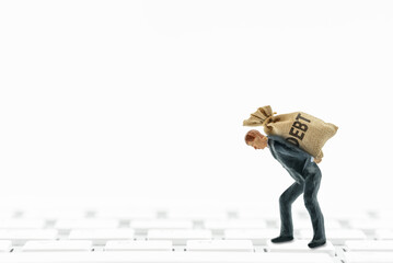 Online debt consolidation, financial concept : Debtor bears a bag of npl debt on a keyboard. Debt consolidation loan is a personal loan that can provide an affordable way to combine multiple debts.