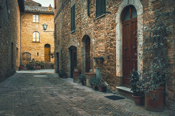 Naklejka premium Cozy arranged street and decorated with colorful plants, Tuscany, Italy