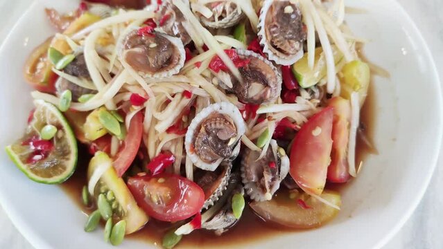 Spicy Papaya Salad with Cockles or Somtum Cockles in Thai language,