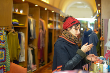 young elegant  girl shopping winter sales design fashion in small local clothing retailer