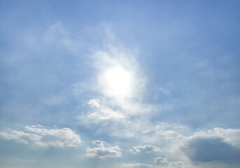 Strong sunlight, blue sky, cumulus clouds.