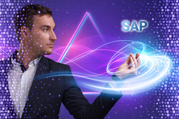 Fototapeta na wymiar Business, Technology, Internet and network concept. Young businessman working on a virtual screen of the future and sees the inscription: SAP
