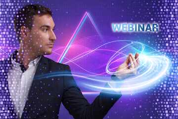 Business, Technology, Internet and network concept. Young businessman working on a virtual screen of the future and sees the inscription: Webinar