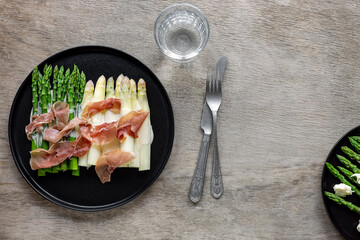 White and green asparagus with prosciutto ham and sauce. Great seasonal food, easy cooking meal for...