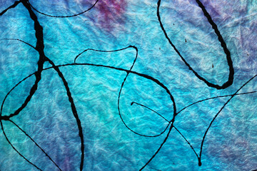 Naklejka premium Antique Blue Glass With Black Paint Splashed on surface and Light Shining through back
