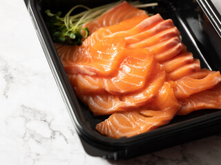Fresh salmon sashimi in a lunch box
