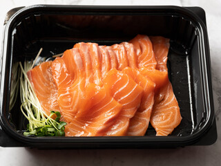 Fresh salmon sashimi in a lunch box