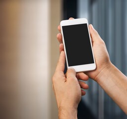 Hand holding phone with black screen on pastel background. Showing empty screen of modern cellphone.