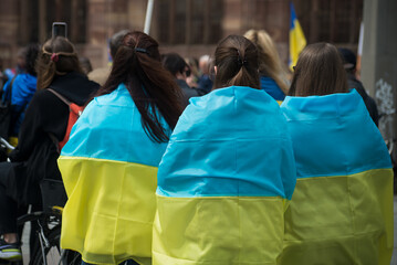 Strasbourg - France - 24 April 2022 - Portrait on back view of woman with ukrainian flag against the war