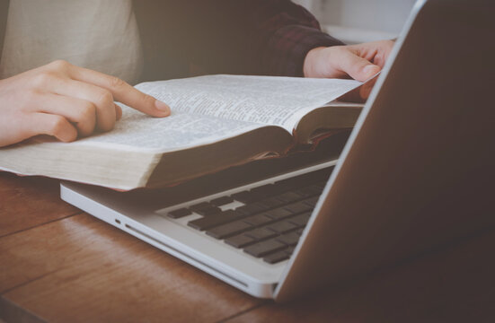 Online Bible Study Ideas.  Female Hand Pointing To The Bible  And There Was A Computer In Front Of Me.  And Is Safe From The Spread Of The COVID-19 Virus.