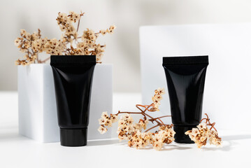 Black Bottle tube with ingredients for skin care and treatment vitamin on white background, Natural cosmetics concept.