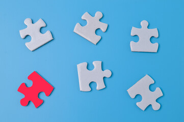 Unique red piece of puzzle among white puzzles. Society, social group, leadership qualities and talent concept