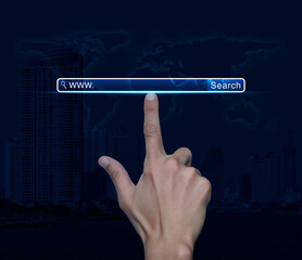 Hand pressing search www button over world map, modern city tower and skyscraper, Searching system and internet concept, Elements of this image furnished by NASA