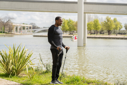 african american man exercising with ropes in park