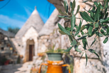 Group of beautiful Trulli or Trullo house, traditional Apulian dry stone hut with a conical roof...